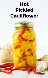 glass jar with hot pickled cauliflower and fresh peppers and text overlay